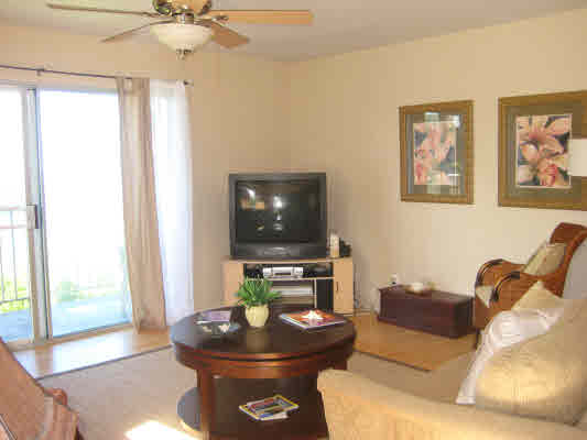 3780 Edward Road, Unit 5201 Princeville, HI 96722 - Photo 8 of 23 a living room with furniture and a flat screen tv