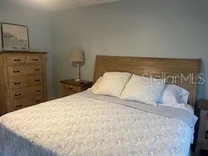 a large bed sitting in a bedroom and dresser