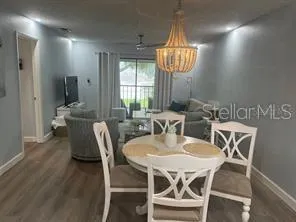 a view of a dining room with furniture wooden floor and chandelier
