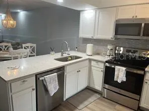 a kitchen with a sink stove and microwave