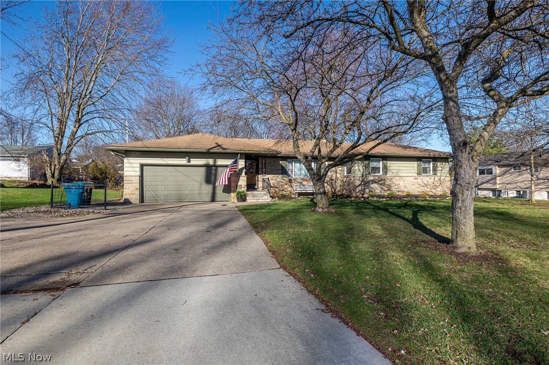 180 South Leavitt Road Amherst, OH 44001 - Photo 1 of 37 Ranch-style house featuring an attached garage, concrete driveway, and a front lawn