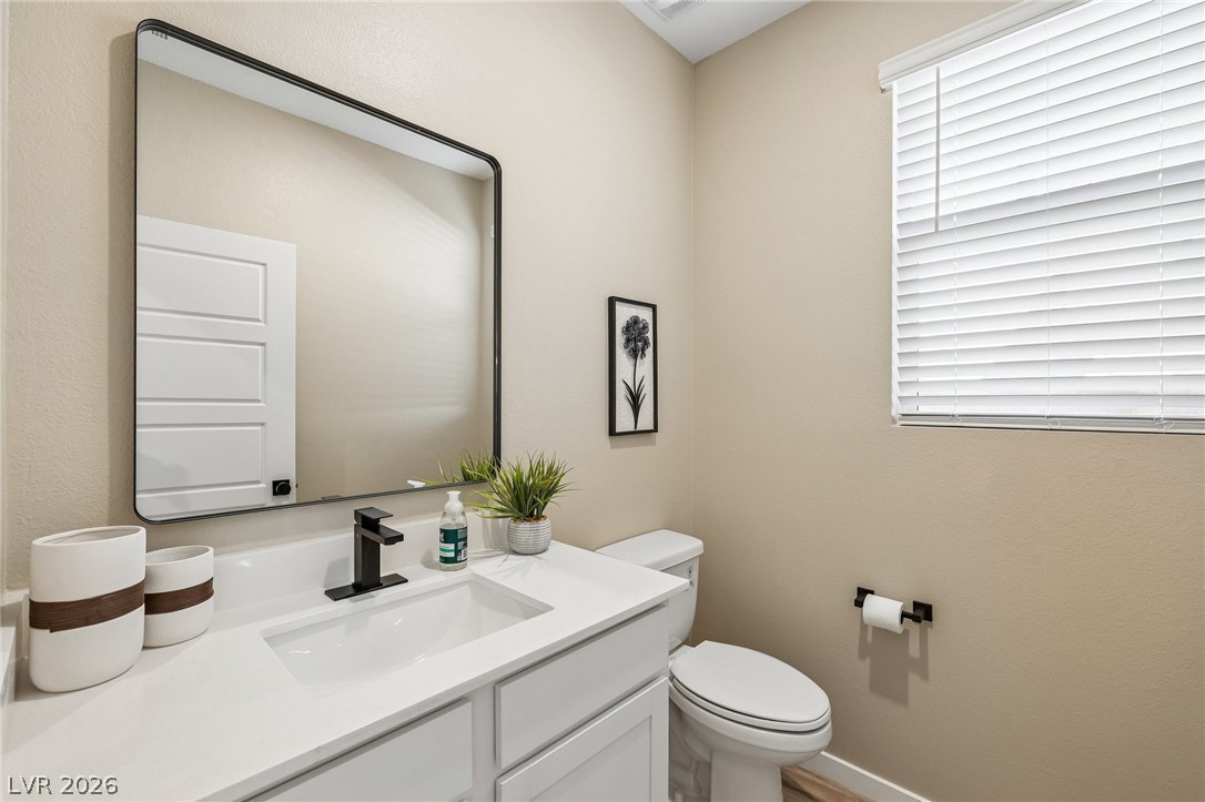 194 Viento Ridge Street Henderson, NV 89012 - Photo 16 of 72 Clean lines and a modern vanity define this elegant half bath.