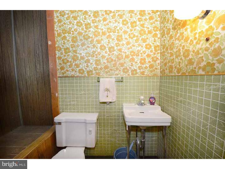 7216 Bradford Road Upper Darby, PA 19082 - Photo 13 of 25 a bathroom with a sink a toilet and mirror
