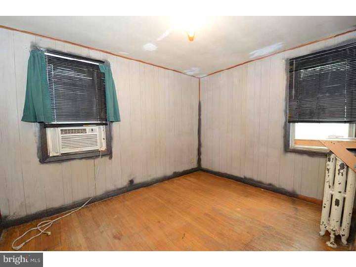 7216 Bradford Road Upper Darby, PA 19082 - Photo 15 of 25 a view of an empty room with wooden floor and a window