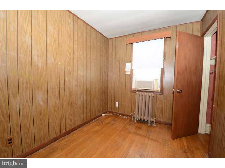 7216 Bradford Road Upper Darby, PA 19082 - Photo 17 of 25 a view of an empty room and wooden door