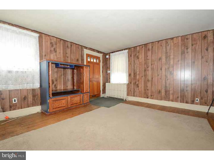 7216 Bradford Road Upper Darby, PA 19082 - Photo 4 of 25 a view of an empty room with wooden floor and windows