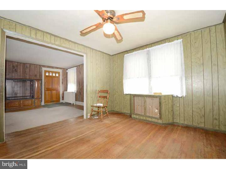 7216 Bradford Road Upper Darby, PA 19082 - Photo 8 of 25 a view of an empty room with a window and wooden floor