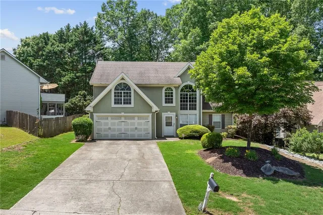 a front view of house with yard and green space