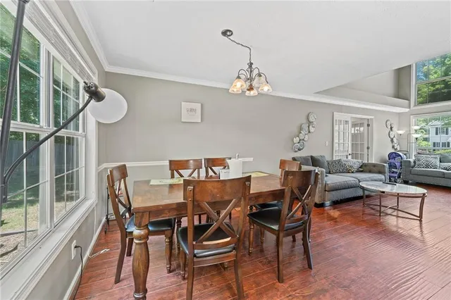 a view of a dining room with furniture window and wooden floor