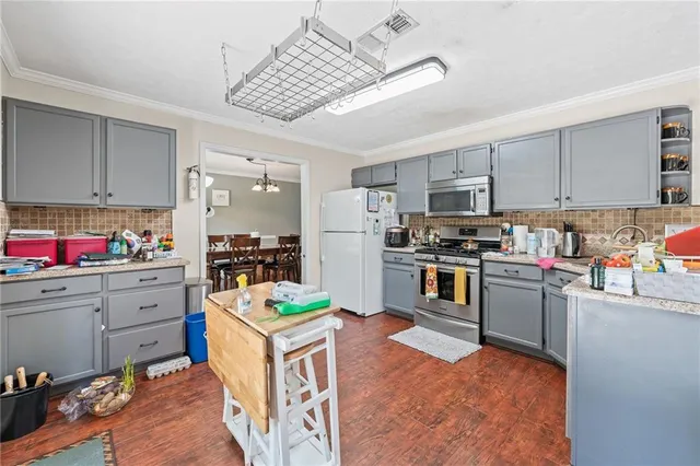 a kitchen with stainless steel appliances granite countertop lots of counter top space