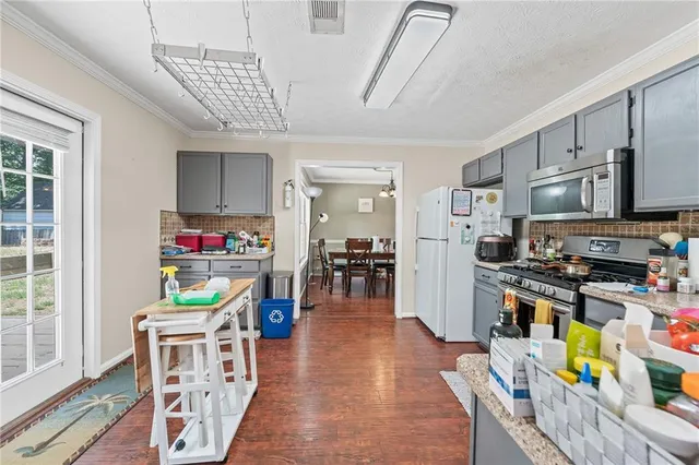 a living room with furniture a fireplace and a table