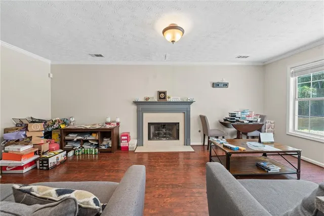 a view of a hallway with wooden floor and cabinet