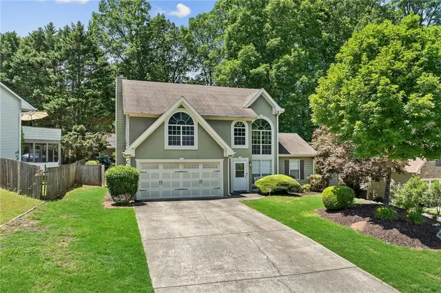 a front view of a house with garden