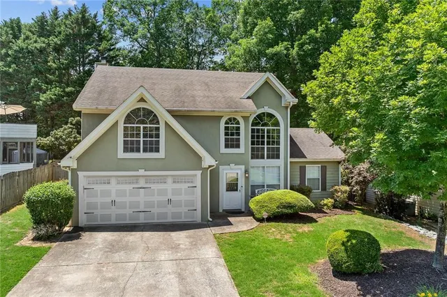 a front view of a house with a yard and garage