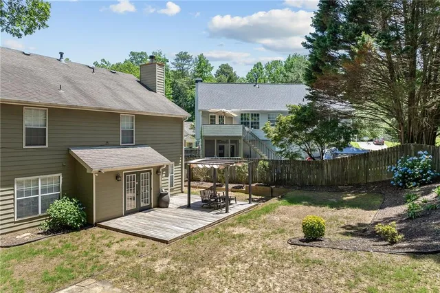 a view of a backyard and floor to ceiling window and tree