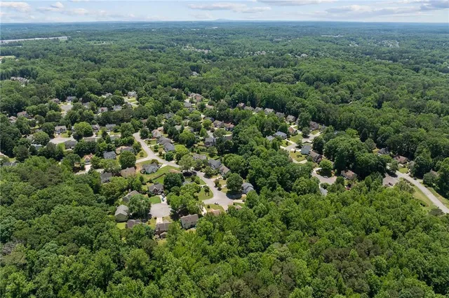 an aerial view of a house with a yard