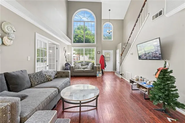a living room with furniture and a wooden floor