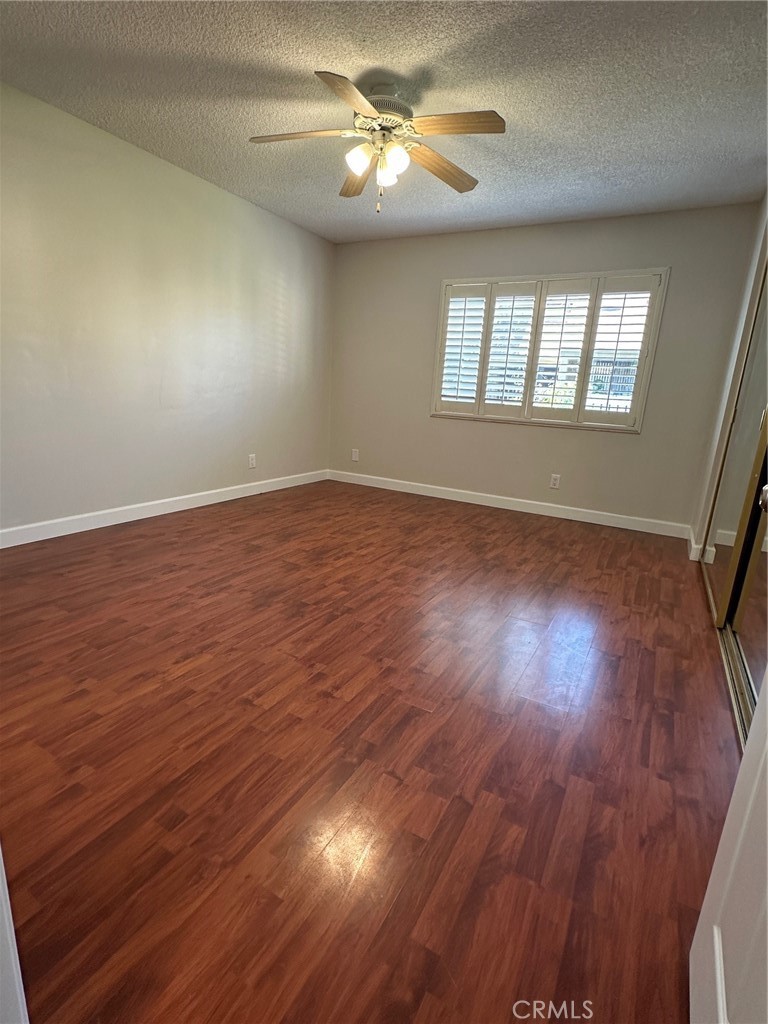 22 Country Mile Road Pomona, CA 91766 - Photo 12 of 16 wooden floor in an empty room with a window