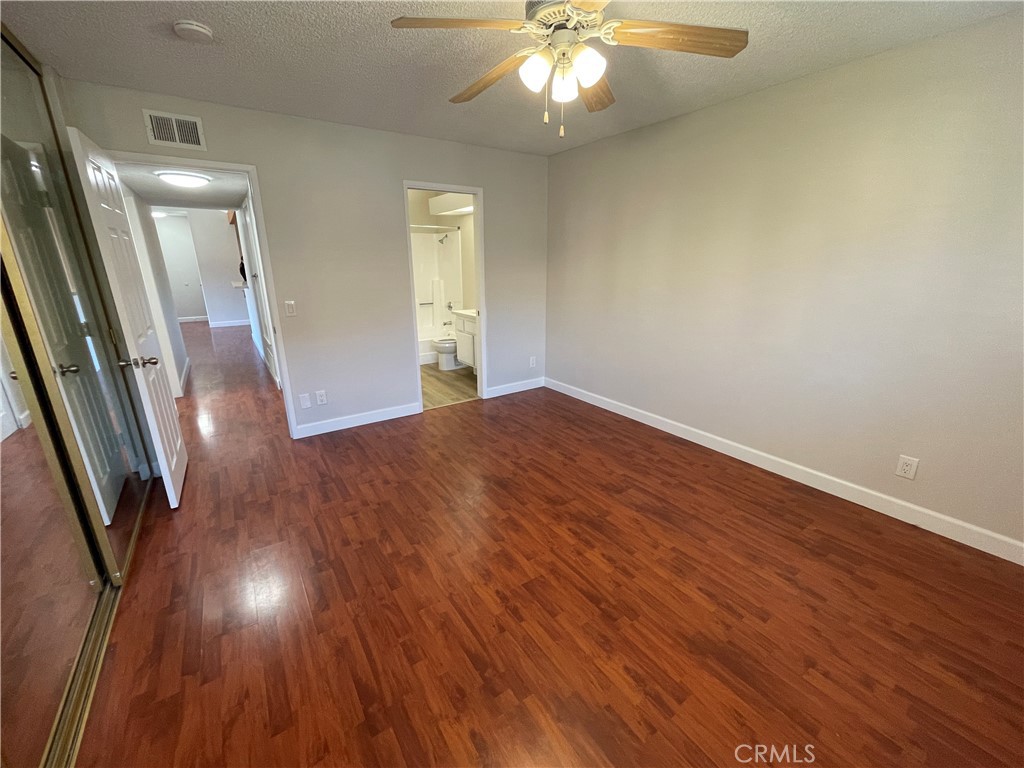 22 Country Mile Road Pomona, CA 91766 - Photo 13 of 16 an empty room with wooden floor and staircase