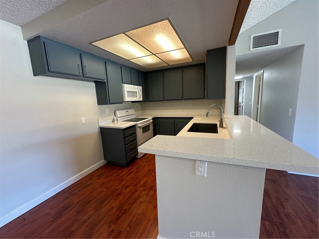 22 Country Mile Road Pomona, CA 91766 - Photo 9 of 16 a kitchen with stainless steel appliances a refrigerator and a stove