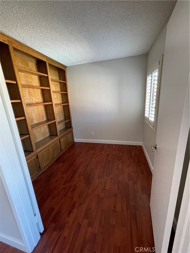 22 Country Mile Road Pomona, CA 91766 - Photo 10 of 16 an empty room with wooden floor and windows