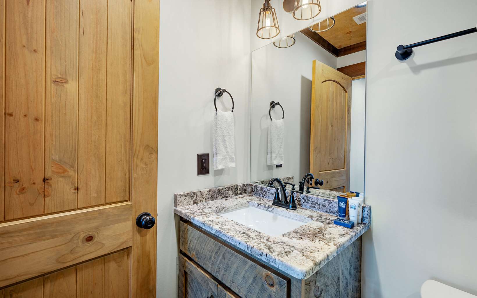 810 Overlook Drive Blue Ridge, GA 30513 - Photo 32 of 56 a bathroom with a granite countertop sink and a mirror