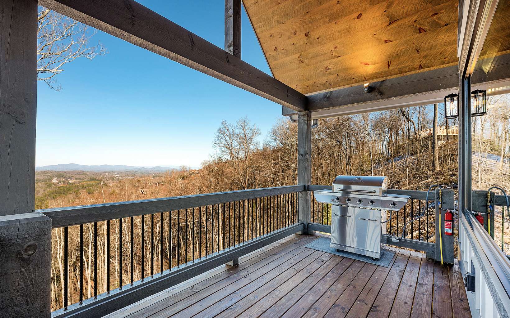 810 Overlook Drive Blue Ridge, GA 30513 - Photo 4 of 56 a view of a balcony with chairs and wooden floor
