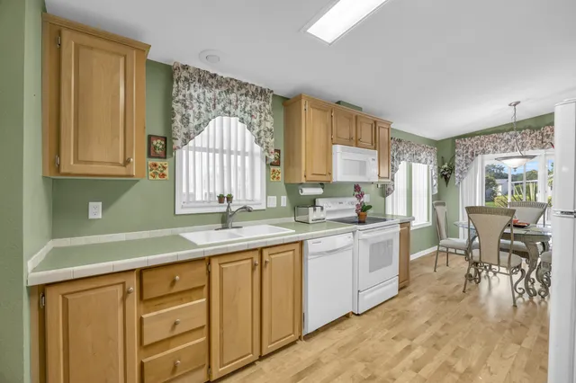 a kitchen with a sink cabinets and window
