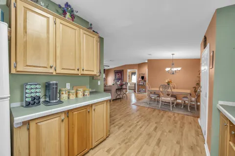 a kitchen with stainless steel appliances granite countertop sink stove and wooden floor
