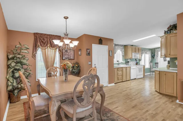a view of a dining room kitchen and a chandelier