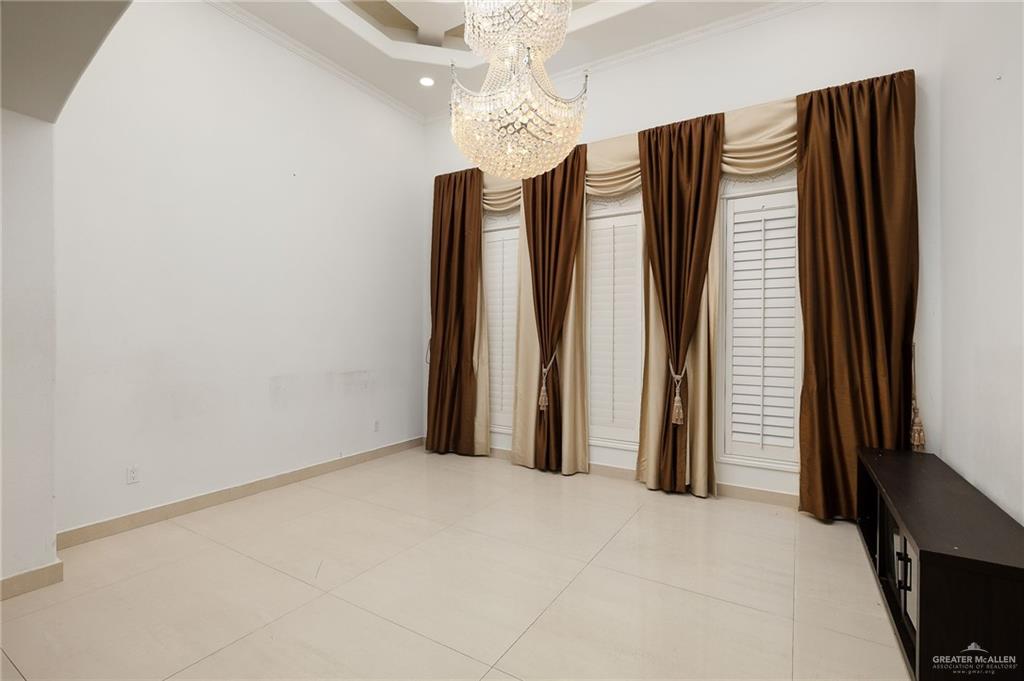 22111 Uresti Road Edinburg, TX 78542 - Photo 6 of 38 Vaulted ceiling with an ornate chandelier, recessed lighting, plantation shutters, and large format tile flooring