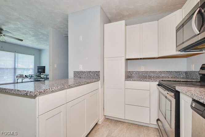 1637 Piney Road North Fort Myers, FL 33903 - Photo 12 of 41 a kitchen with stainless steel appliances granite countertop white cabinets and a sink