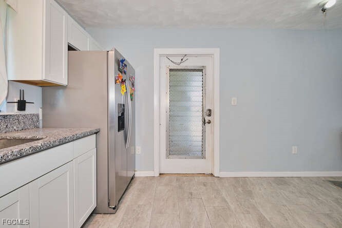 1637 Piney Road North Fort Myers, FL 33903 - Photo 14 of 41 a view of hallway with granite countertop cabinets and sink