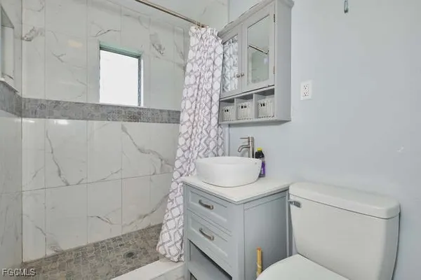 a bathroom with a sink toilet and shower