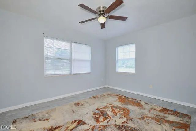 a room with wooden floor and a window