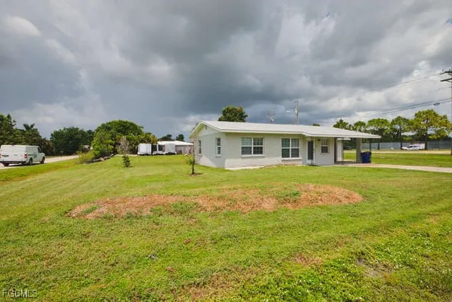 an aerial view of residential houses with outdoor space and trees