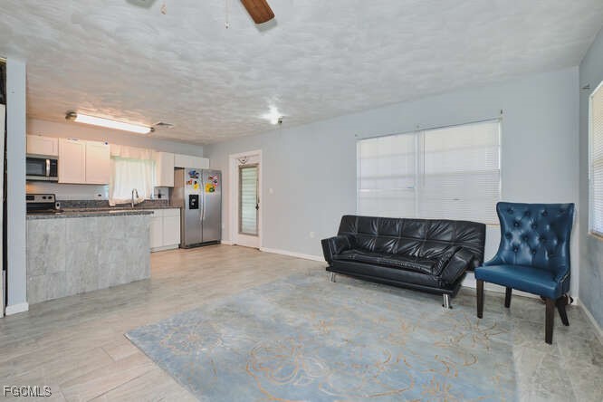 1637 Piney Road North Fort Myers, FL 33903 - Photo 7 of 41 a living room with furniture and kitchen view