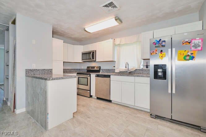 1637 Piney Road North Fort Myers, FL 33903 - Photo 10 of 41 a kitchen with refrigerator cabinets and microwave