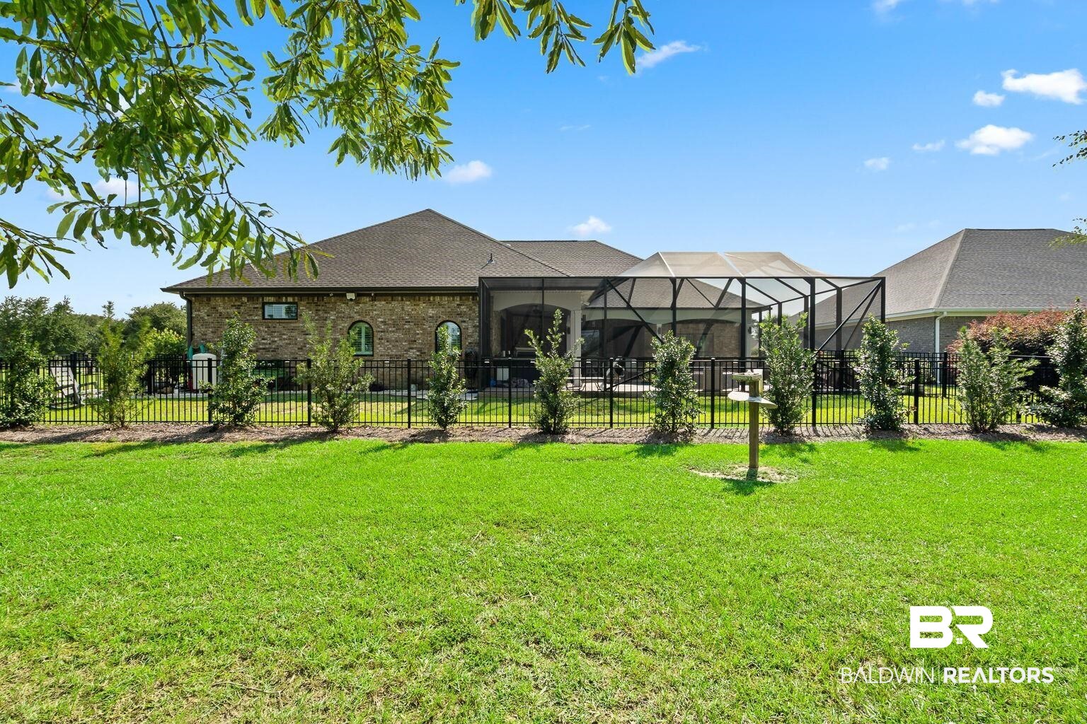 23357 Carnoustie Drive Foley, AL 36535 - Photo 89 of 99 Back of house with a fenced backyard, glass enclosure, and brick siding
