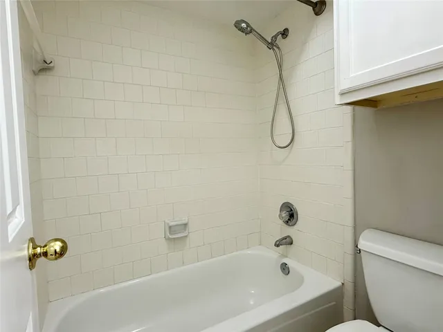 a bathroom with a bath tub with a shower
