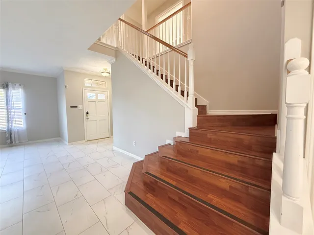 a view of entryway and hall with wooden floor
