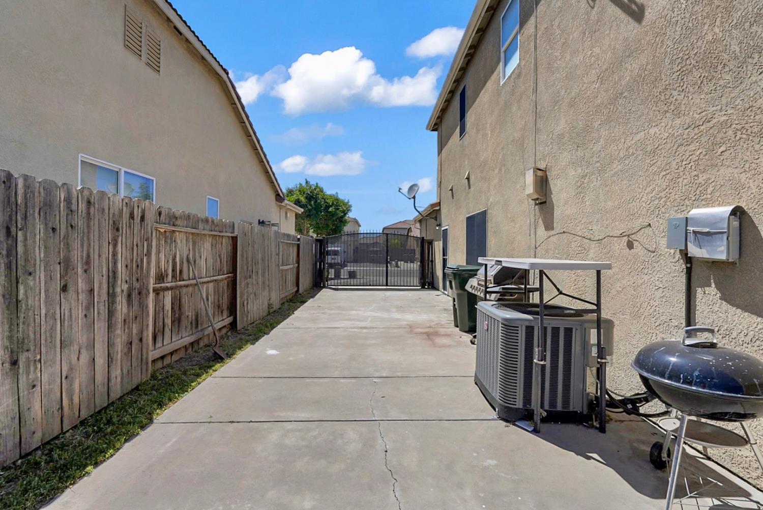 1412 Red Ribbons Lane Manteca, CA 95337 - Photo 18 of 32 a view of a patio with wooden fence