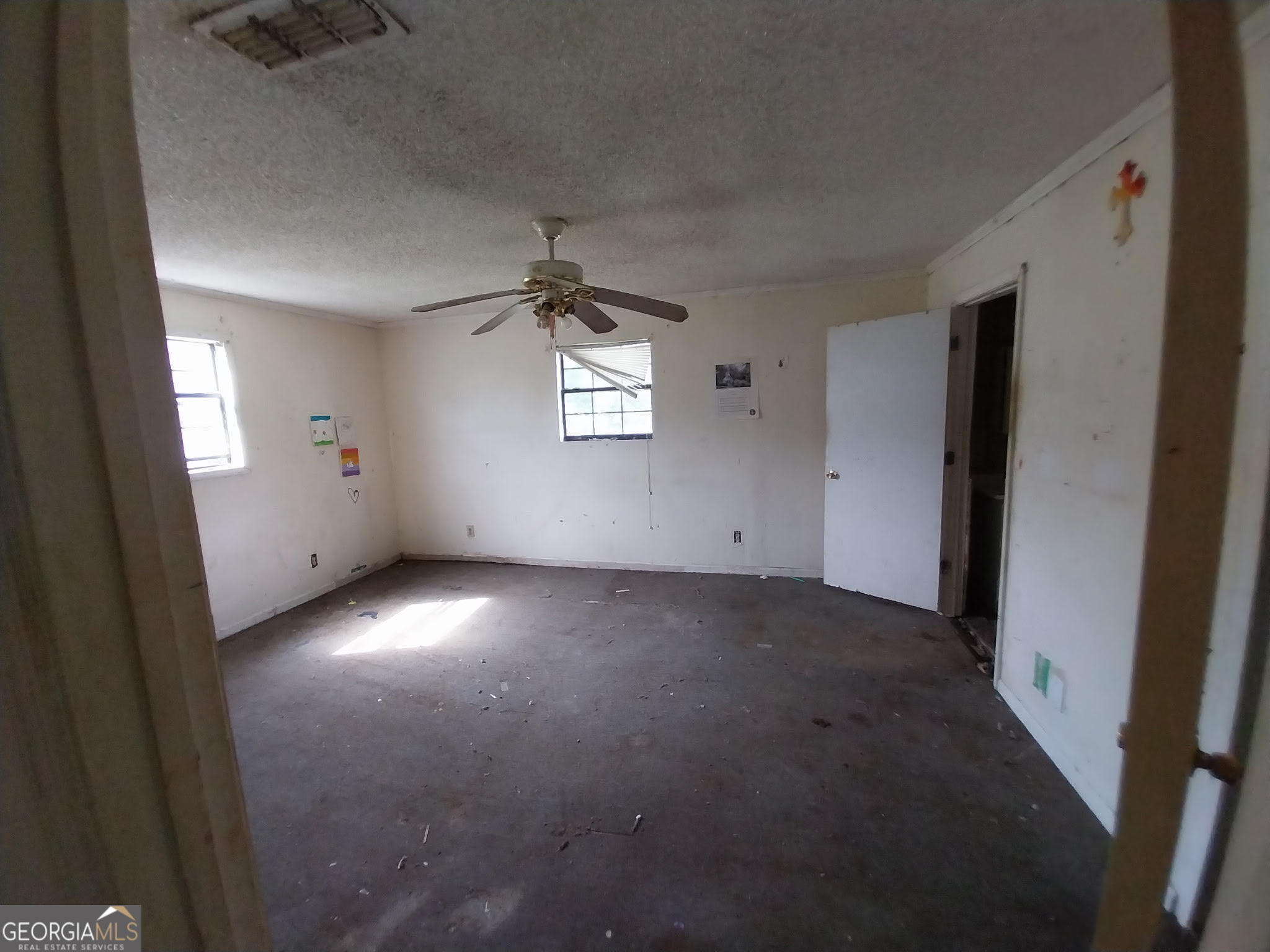 152 Seaweed Road Fitzgerald, GA 31750 - Photo 3 of 4 an empty room with a empty space and windows