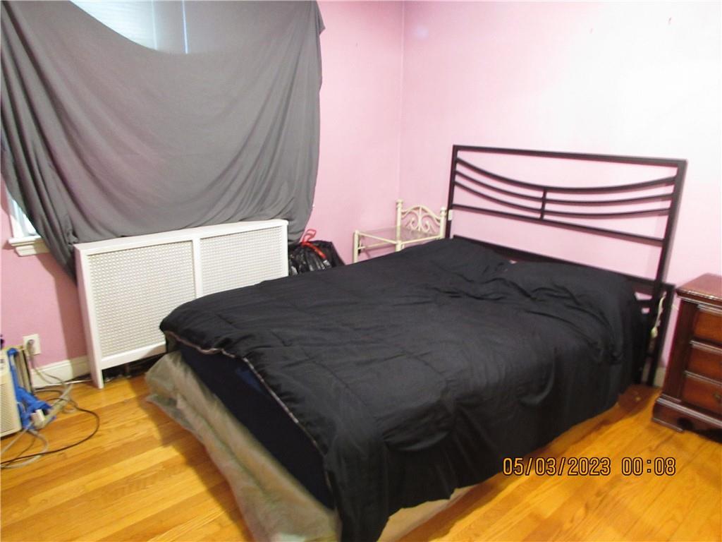 2806 Sexton Place Bronx, NY 10469 - Photo 16 of 18 a bed sitting in a bedroom next to a window