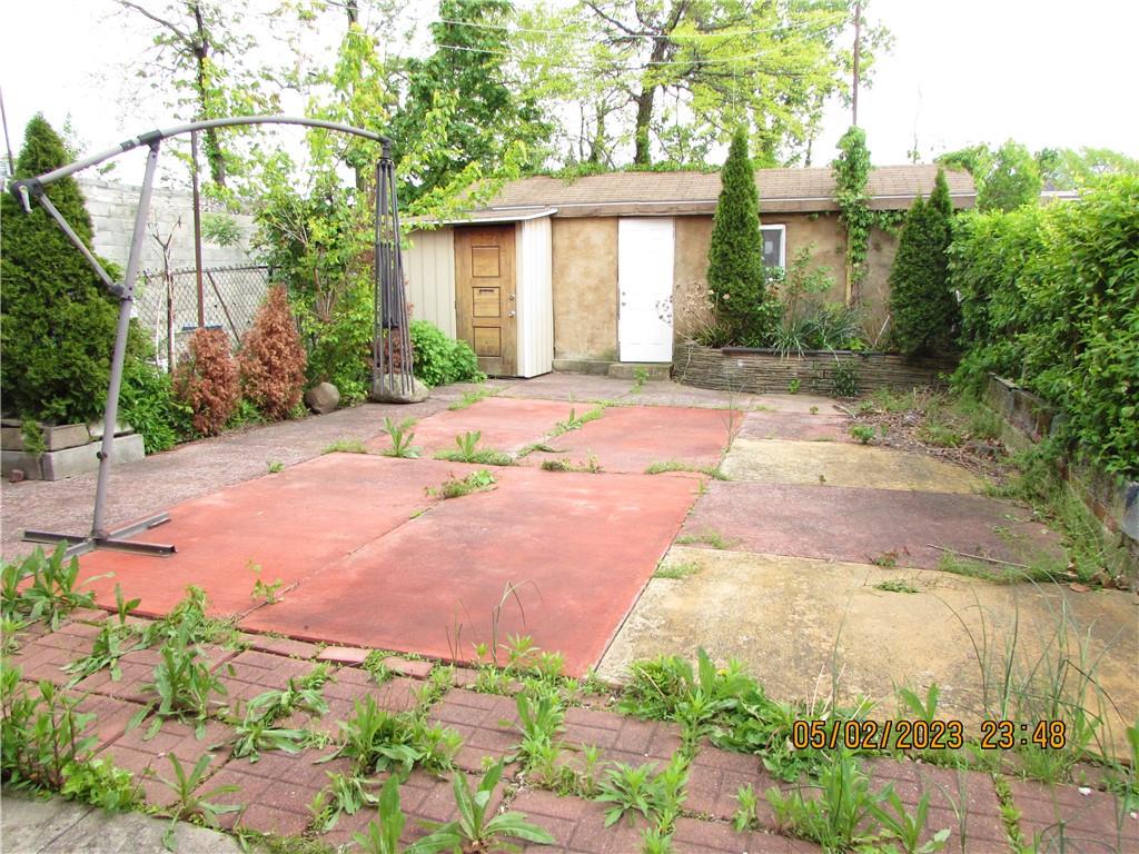 2806 Sexton Place Bronx, NY 10469 - Photo 4 of 18 a front view of a house with a yard and a garage