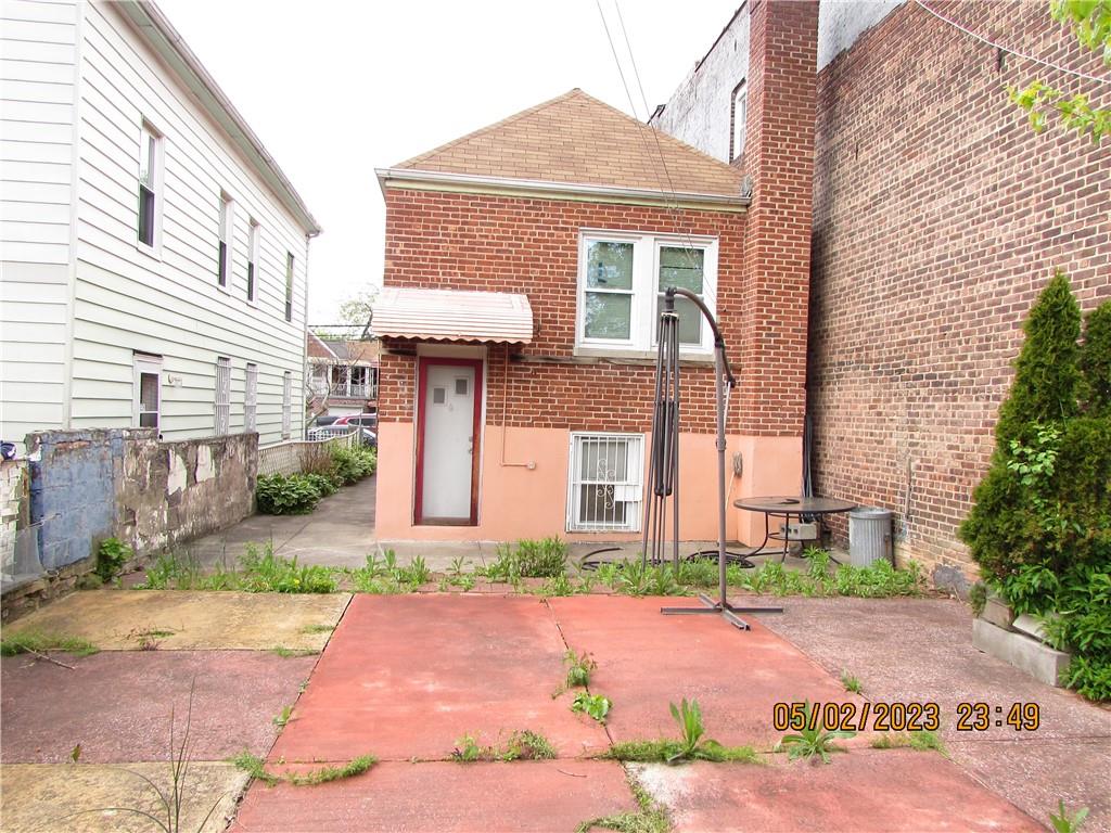 2806 Sexton Place Bronx, NY 10469 - Photo 5 of 18 a front view of a house with a yard and a garage