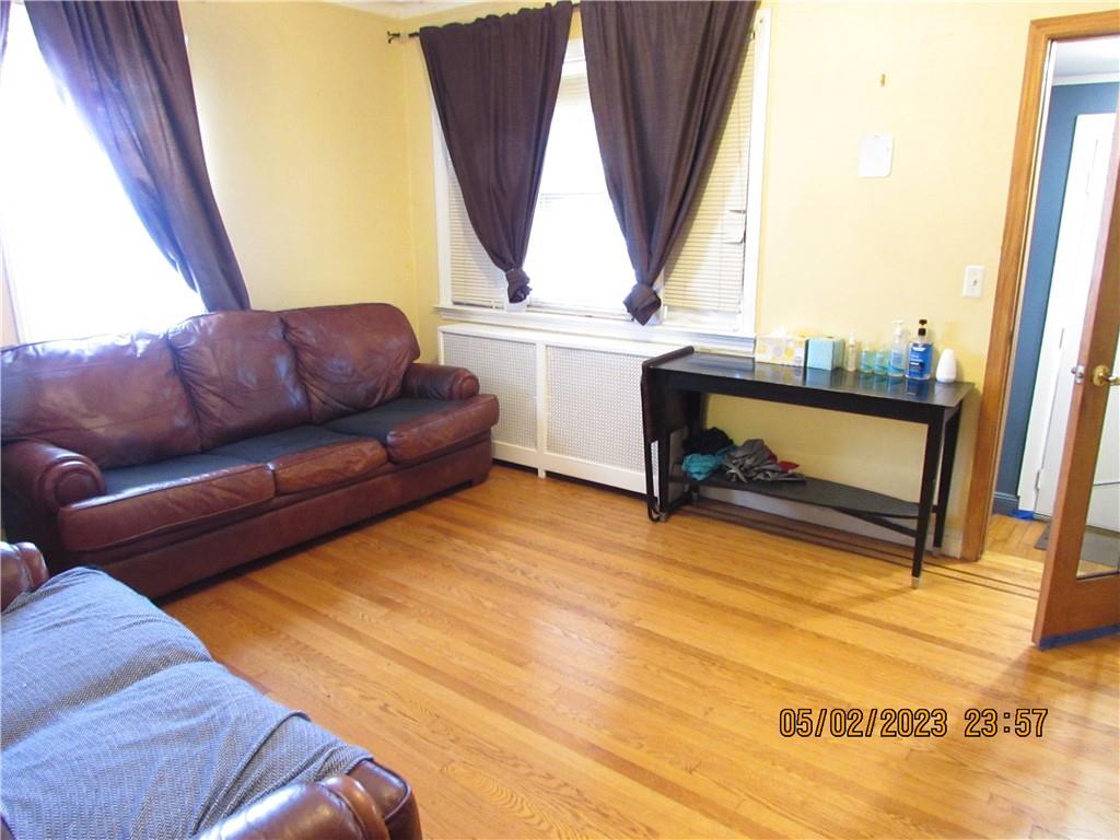 2806 Sexton Place Bronx, NY 10469 - Photo 7 of 18 a living room with a couch and a window