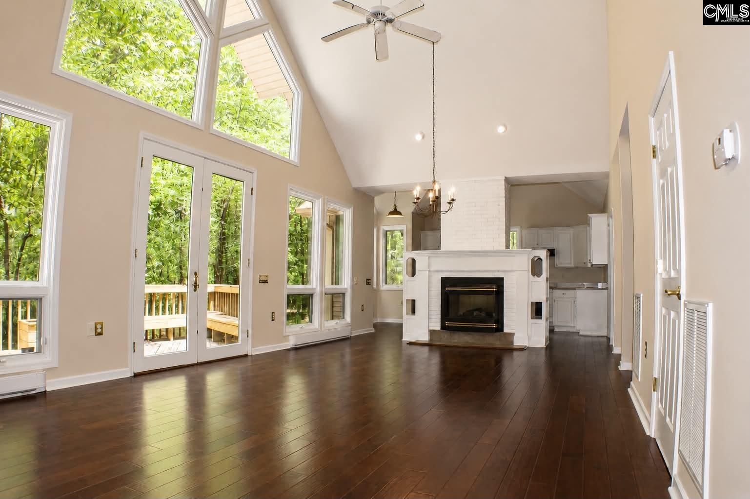 111 Lakeview Road Eastover, SC 29044 - Photo 8 of 39 an empty room with floor to ceiling windows and a fireplace