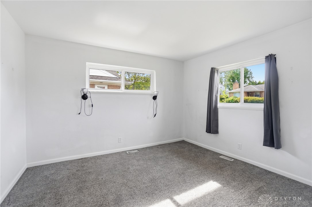 629 Storms Road Dayton, OH 45429 - Photo 39 of 51 This bright and airy room features soft carpeting and abundant natural light from multiple windows.