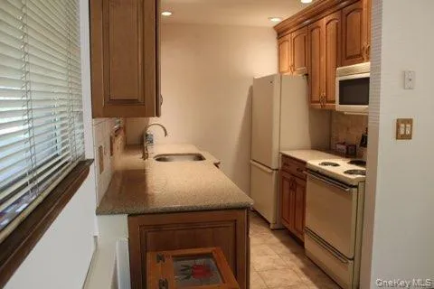 a kitchen with kitchen island a sink appliances and cabinets